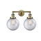 Beacon Bath Vanity Light shown in the Antique Brass finish with a Clear shade