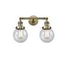 Beacon Bath Vanity Light shown in the Antique Brass finish with a Seedy shade