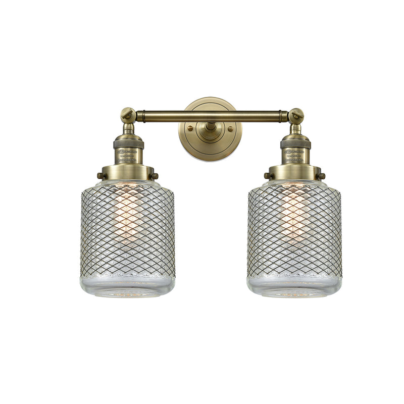 Stanton Bath Vanity Light shown in the Antique Brass finish with a Clear Wire Mesh shade