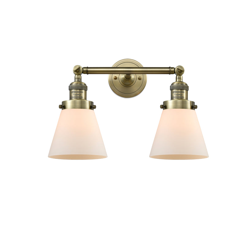 Cone Bath Vanity Light shown in the Antique Brass finish with a Matte White shade