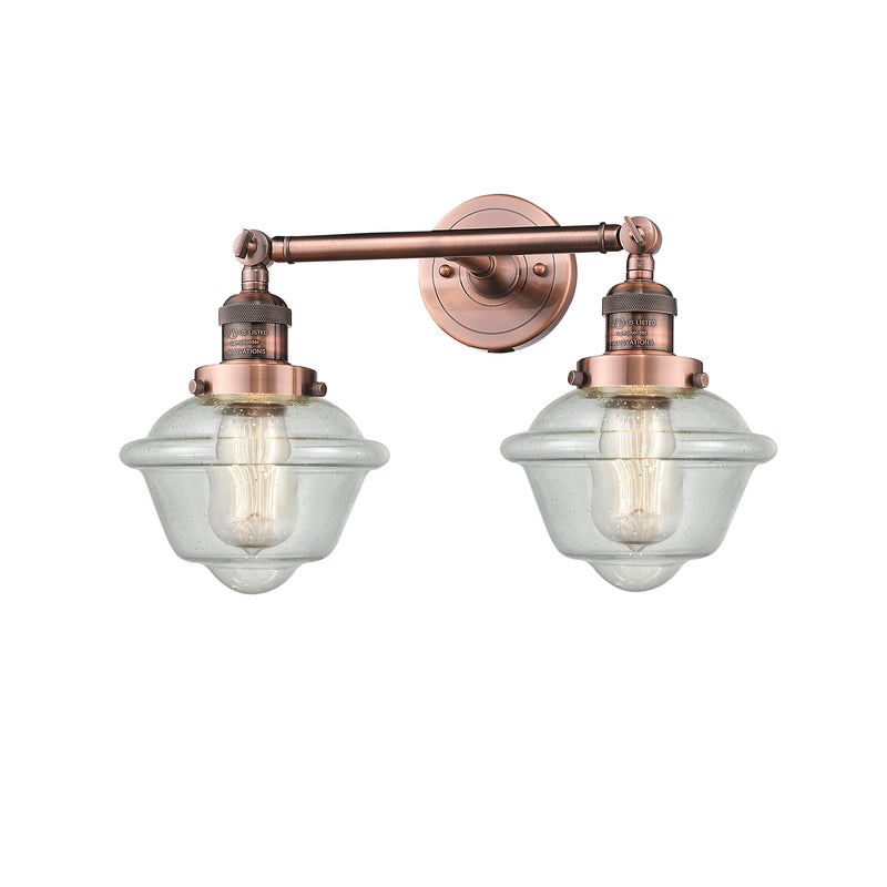 Oxford Bath Vanity Light shown in the Antique Copper finish with a Seedy shade