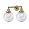 Beacon Bath Vanity Light shown in the Brushed Brass finish with a Seedy shade