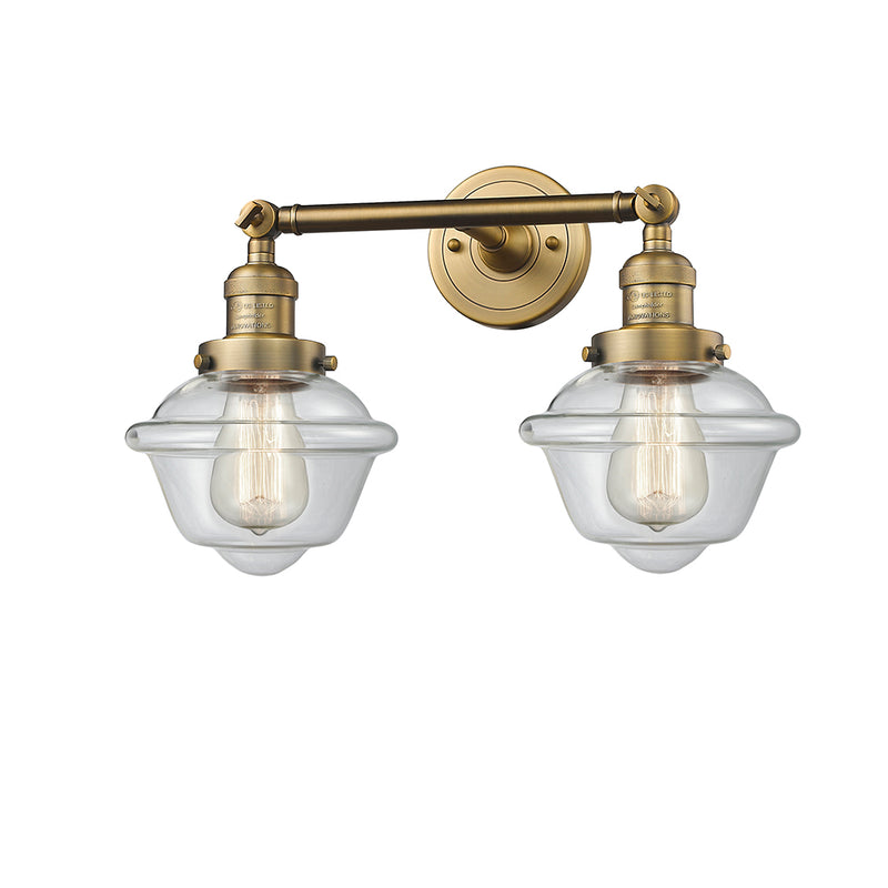 Oxford Bath Vanity Light shown in the Brushed Brass finish with a Clear shade