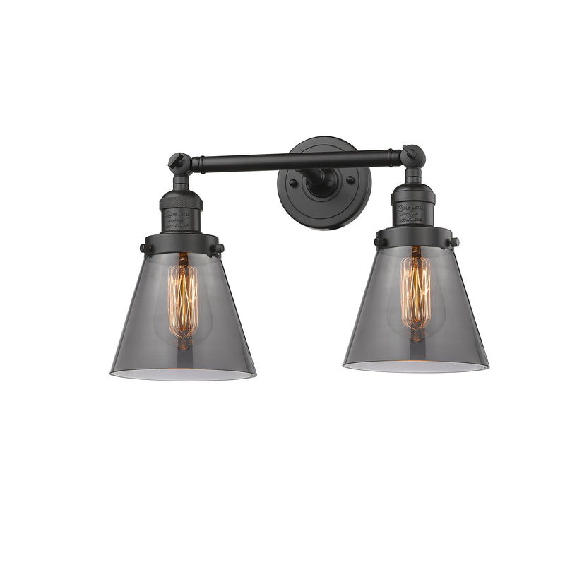 Cone Bath Vanity Light shown in the Oil Rubbed Bronze finish with a Plated Smoke shade