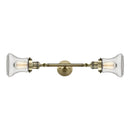 Bellmont Bath Vanity Light shown in the Antique Brass finish with a Clear shade