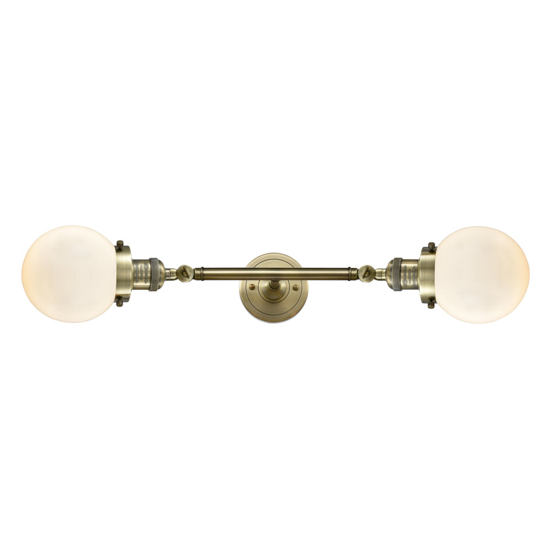 Beacon Bath Vanity Light shown in the Antique Brass finish with a Matte White shade