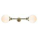 Beacon Bath Vanity Light shown in the Antique Brass finish with a Matte White shade