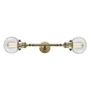 Beacon Bath Vanity Light shown in the Antique Brass finish with a Clear shade