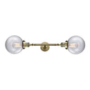 Beacon Bath Vanity Light shown in the Antique Brass finish with a Clear shade