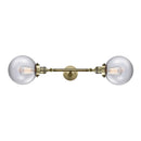 Beacon Bath Vanity Light shown in the Antique Brass finish with a Clear shade