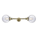 Beacon Bath Vanity Light shown in the Antique Brass finish with a Seedy shade