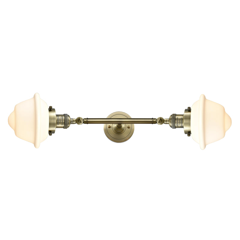 Oxford Bath Vanity Light shown in the Antique Brass finish with a Matte White shade