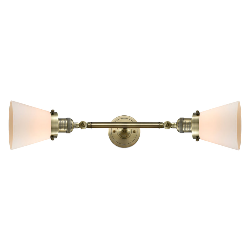 Cone Bath Vanity Light shown in the Antique Brass finish with a Matte White shade