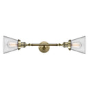 Cone Bath Vanity Light shown in the Antique Brass finish with a Clear shade