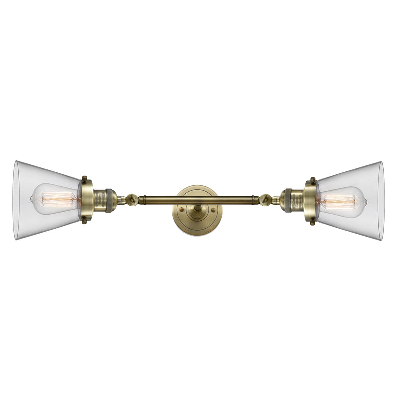 Cone Bath Vanity Light shown in the Antique Brass finish with a Clear shade