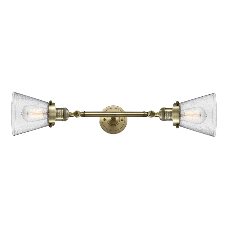 Cone Bath Vanity Light shown in the Antique Brass finish with a Seedy shade