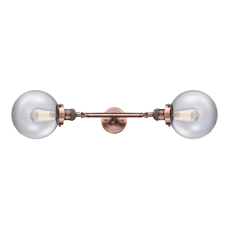 Beacon Bath Vanity Light shown in the Antique Copper finish with a Clear shade