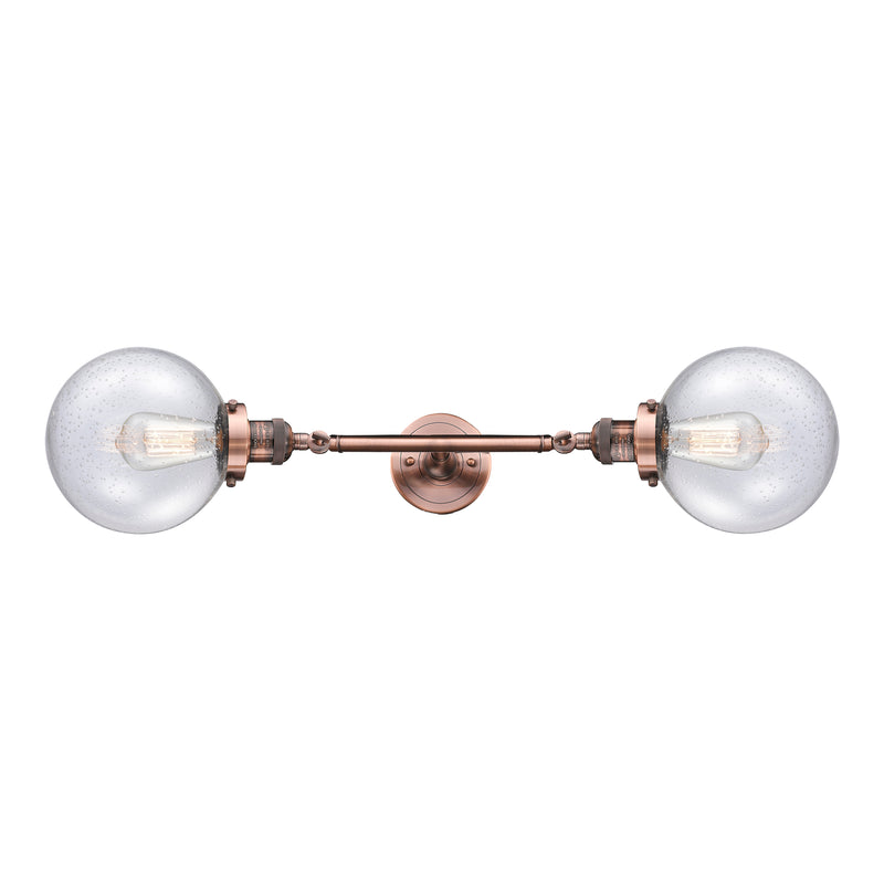 Beacon Bath Vanity Light shown in the Antique Copper finish with a Seedy shade