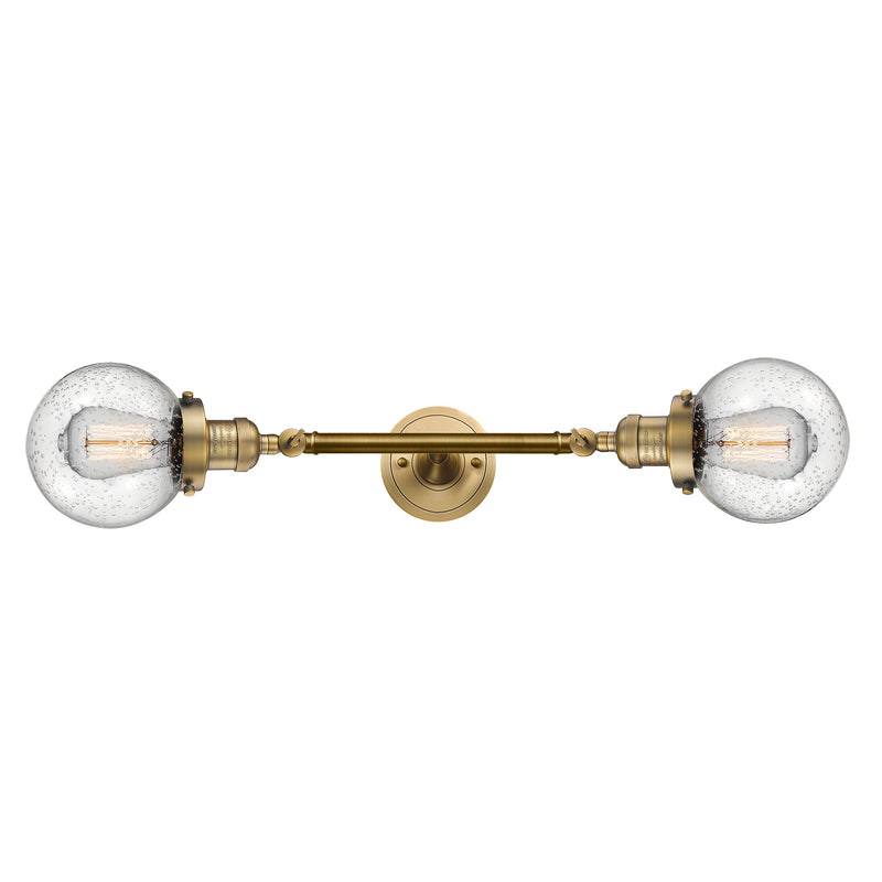 Beacon Bath Vanity Light shown in the Brushed Brass finish with a Seedy shade