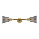 Cone Bath Vanity Light shown in the Brushed Brass finish with a Plated Smoke shade