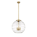 Deco Swirl Pendant shown in the Brushed Brass finish with a Clear shade