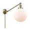 Beacon Swing Arm shown in the Antique Brass finish with a Matte White shade