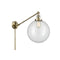 Beacon Swing Arm shown in the Antique Brass finish with a Clear shade