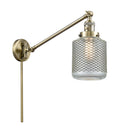 Stanton Swing Arm shown in the Antique Brass finish with a Clear Wire Mesh shade