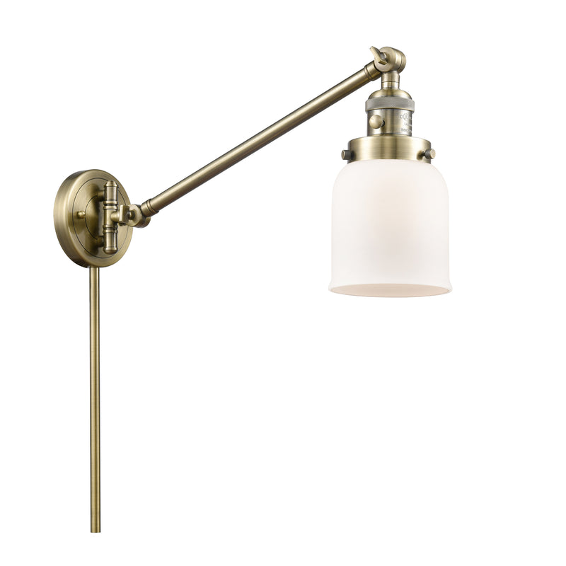 Bell Swing Arm shown in the Antique Brass finish with a Matte White shade