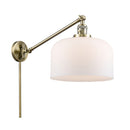 Bell Swing Arm shown in the Antique Brass finish with a Matte White shade