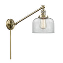 Bell Swing Arm shown in the Antique Brass finish with a Clear shade