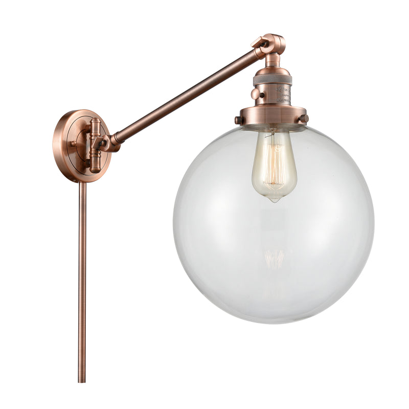 Beacon Swing Arm shown in the Antique Copper finish with a Clear shade