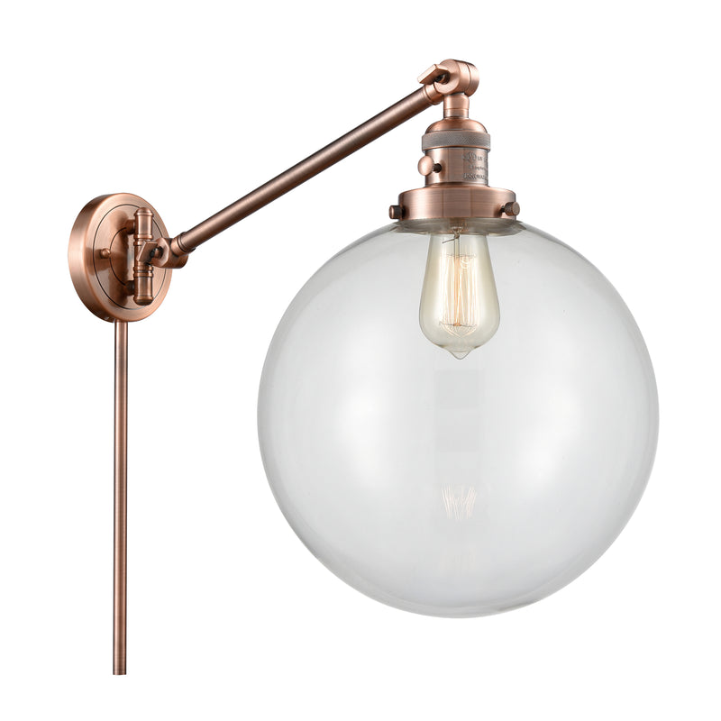 Beacon Swing Arm shown in the Antique Copper finish with a Clear shade