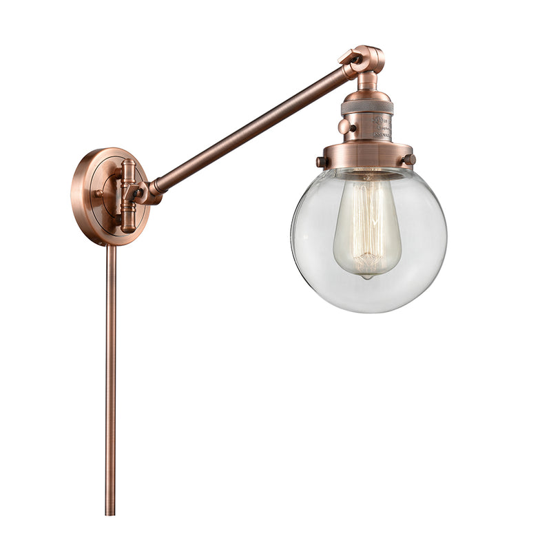 Beacon Swing Arm shown in the Antique Copper finish with a Clear shade