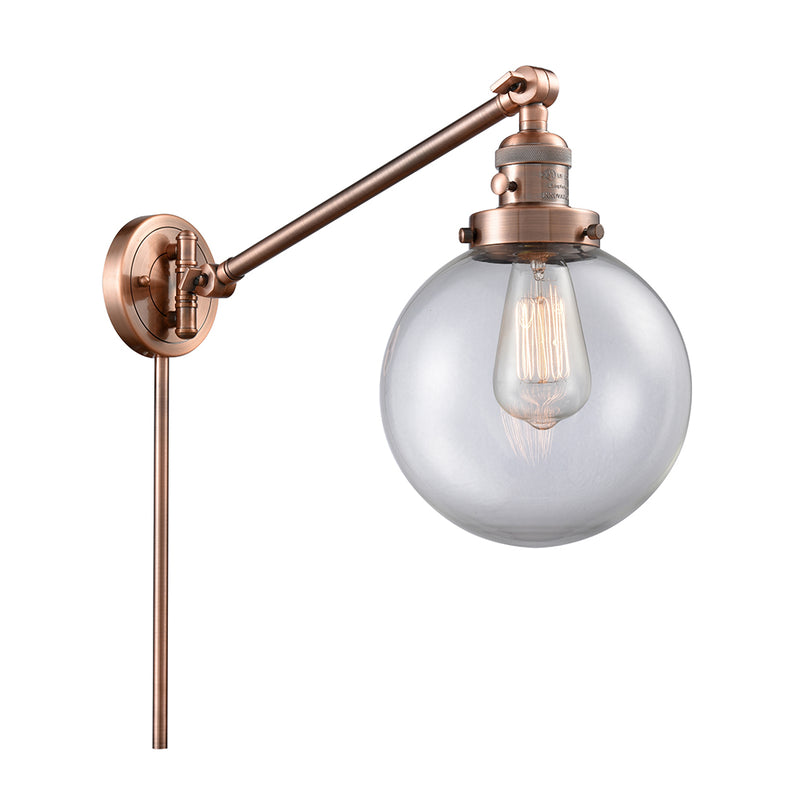 Beacon Swing Arm shown in the Antique Copper finish with a Clear shade