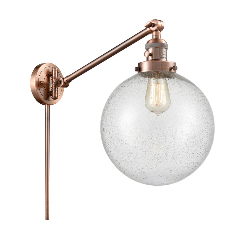 Beacon Swing Arm shown in the Antique Copper finish with a Seedy shade