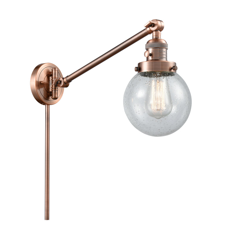 Beacon Swing Arm shown in the Antique Copper finish with a Seedy shade