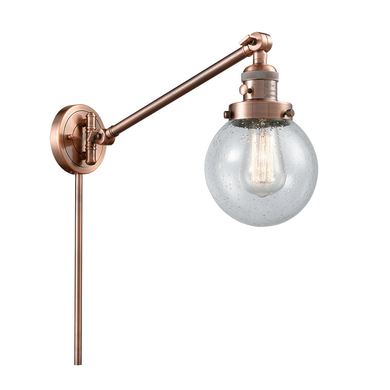 Beacon Swing Arm shown in the Antique Copper finish with a Seedy shade