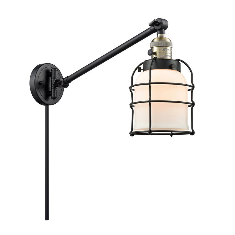 Bell Cage Swing Arm shown in the Black Antique Brass finish with a Matte White shade