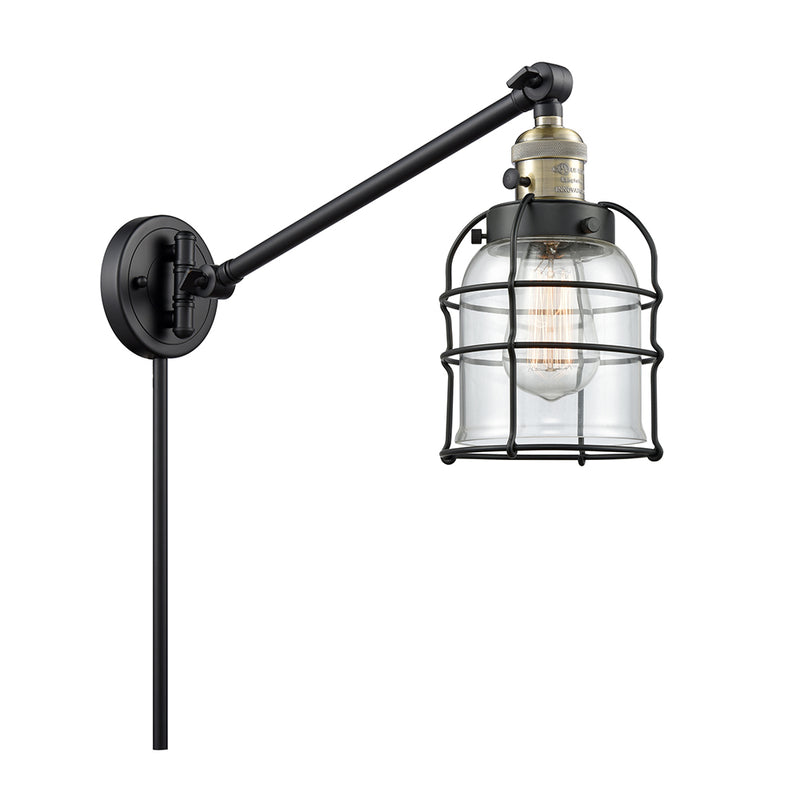 Bell Cage Swing Arm shown in the Black Antique Brass finish with a Clear shade