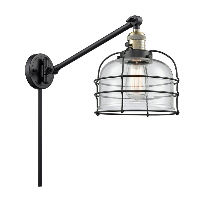 Bell Cage Swing Arm shown in the Black Antique Brass finish with a Clear shade