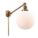 Beacon Swing Arm shown in the Brushed Brass finish with a Matte White shade