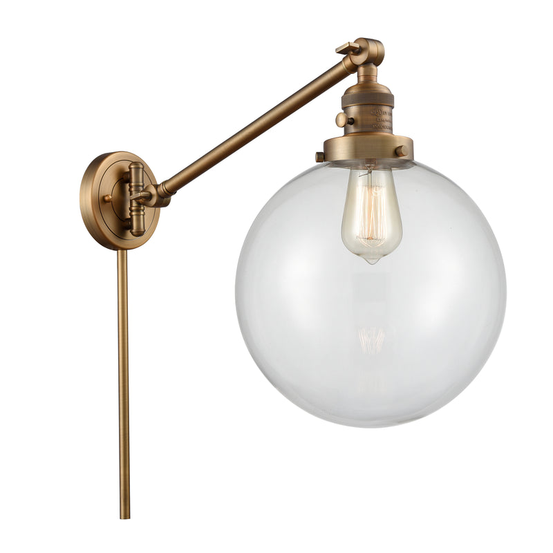 Beacon Swing Arm shown in the Brushed Brass finish with a Clear shade