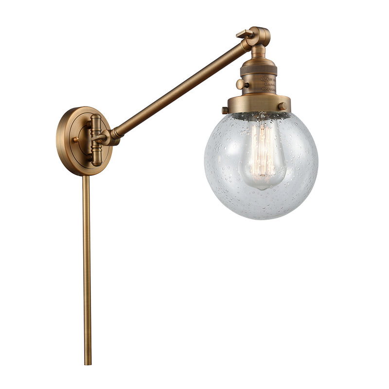 Beacon Swing Arm shown in the Brushed Brass finish with a Seedy shade