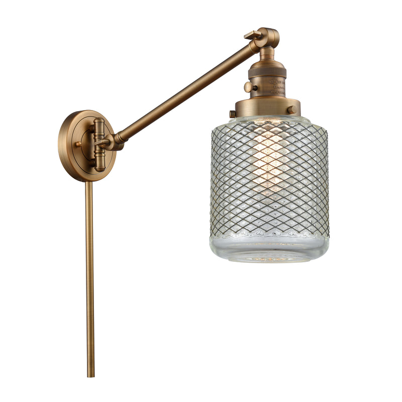 Stanton Swing Arm shown in the Brushed Brass finish with a Clear Wire Mesh shade