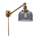 Bell Swing Arm shown in the Brushed Brass finish with a Plated Smoke shade