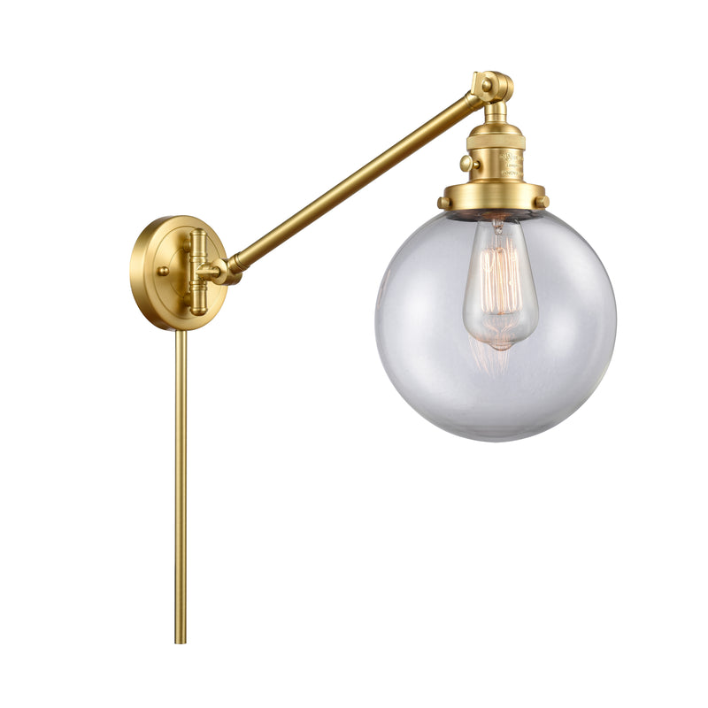 Beacon Swing Arm shown in the Satin Gold finish with a Clear shade