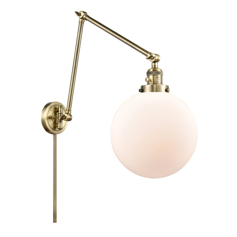 Beacon Swing Arm shown in the Antique Brass finish with a Matte White shade