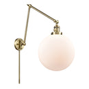 Beacon Swing Arm shown in the Antique Brass finish with a Matte White shade