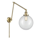 Beacon Swing Arm shown in the Antique Brass finish with a Clear shade